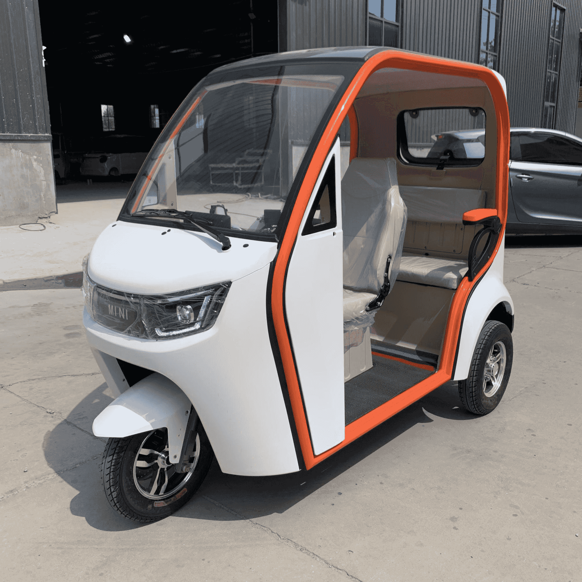 Wholesale 1000W compact electric passenger trike (2-seater). Features a built-in heater, leaf spring suspension & off-road readiness. Get factory FCL quotes.
