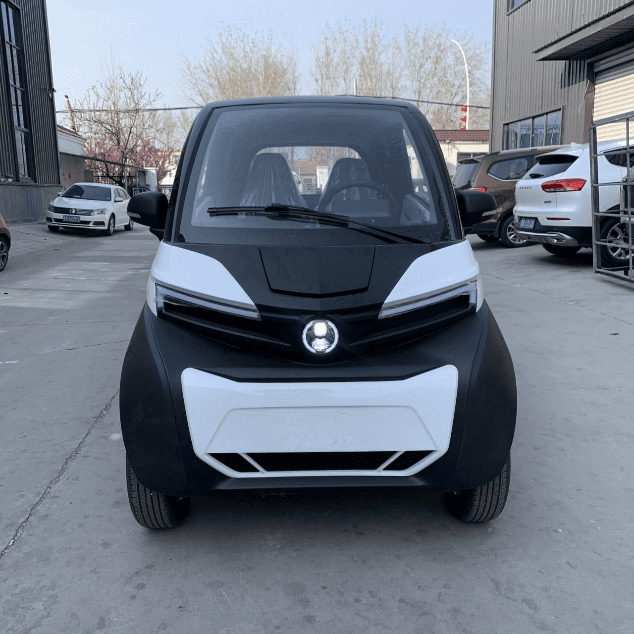 Wholesale premium 1500W enclosed electric shuttle (2-seater). Features 4-wheel disc brakes, electric tailgate & optional A/C. Get factory FCL quotes today.